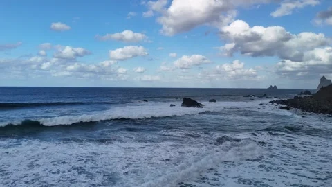 Ocean Waves Breaking Around Coastal Rocks Beneath Clouds Stock Footage 345576429