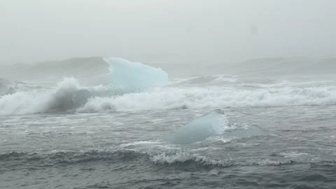 Ocean Waves Breaking Around Glacial Ice Structures at Diamond Beach in Iceland Video stock 339951678