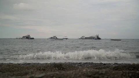 Ocean waves breaking on the beach in the background ships Bali Indonesia Vídeo Stock 126974550
