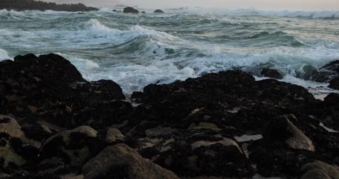 Ocean waves breaking over rocky beach. Pan left. Stock Footage 166815327