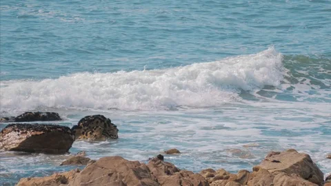Ocean Waves breaking on rocks on beach Stock Footage 104862045