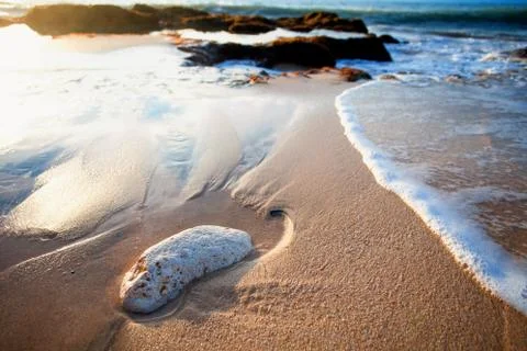 Ocean waves breaking on the rocks on the beach Stock Photos