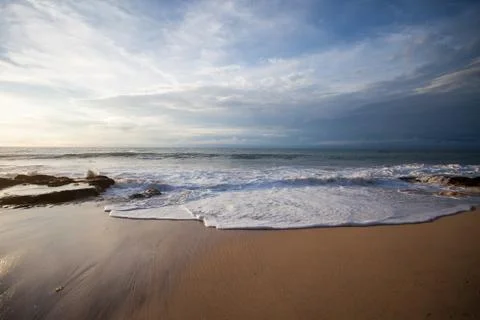 Ocean waves breaking on the rocks on the beach Stock Photos
