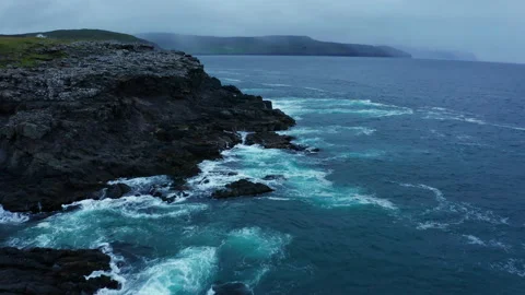 Ocean waves breaking on the rocks on the shore, aerial view. Faroe Islands Stock Footage 168605732