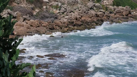 Ocean waves breaking on rocky beach Stock Footage 95269356