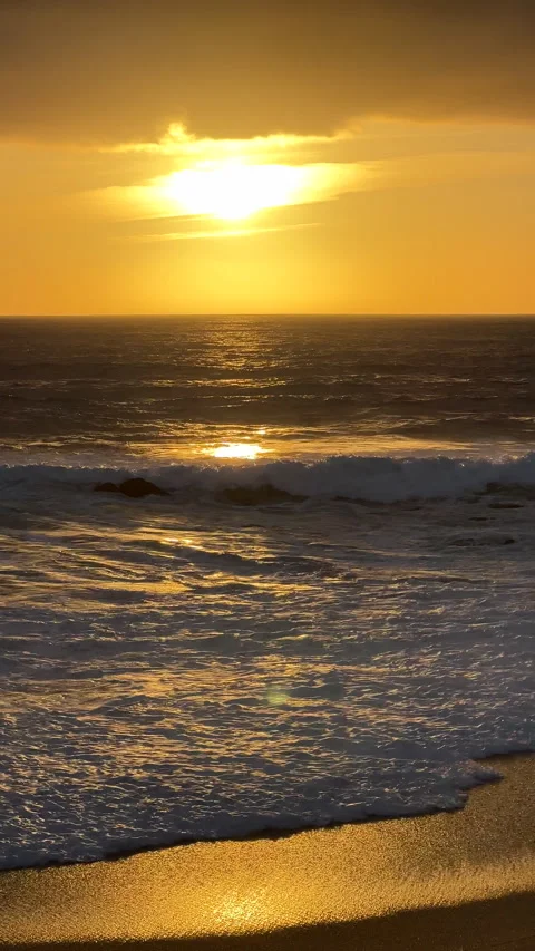 Ocean waves breaking on sandy beach at sunset. Vertical aspect ratio. Stock Footage 238535352