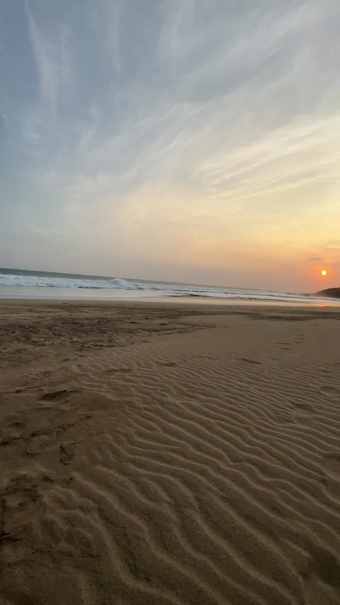 Ocean Waves Breaking on Sandy Beach at Sunset, Tracking Shot, Vertical Stock Footage 324770296