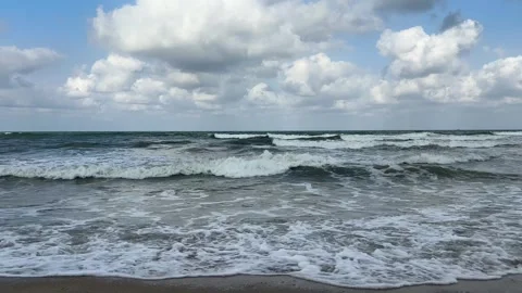 Ocean waves breaking on a sandy beach under a cloudy sky in Malaysia Stock Footage 328336096