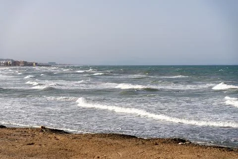 Ocean Waves Breaking on Sandy Beach Under Clear Sky Photos
