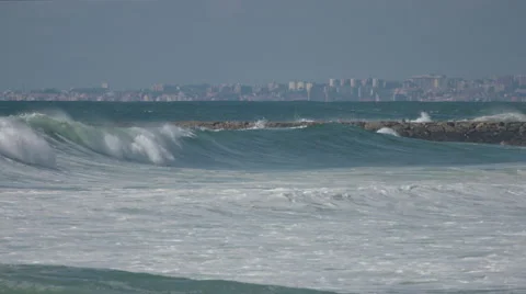 Ocean waves in a cityscape Stock Footage 49735262