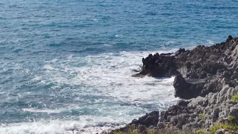 Ocean Waves Collides with Large Rocks Breaking on the Edge of Rocks. Stock Footage 220663439
