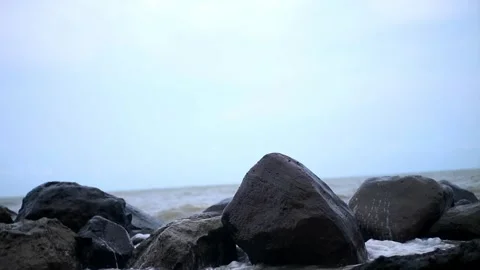 Ocean waves that continue to crash into large rocks Stock Footage 262362196
