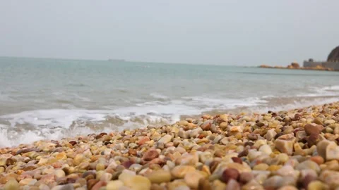 The ocean waves crash against the beach and pebbles Stock Footage 343608254