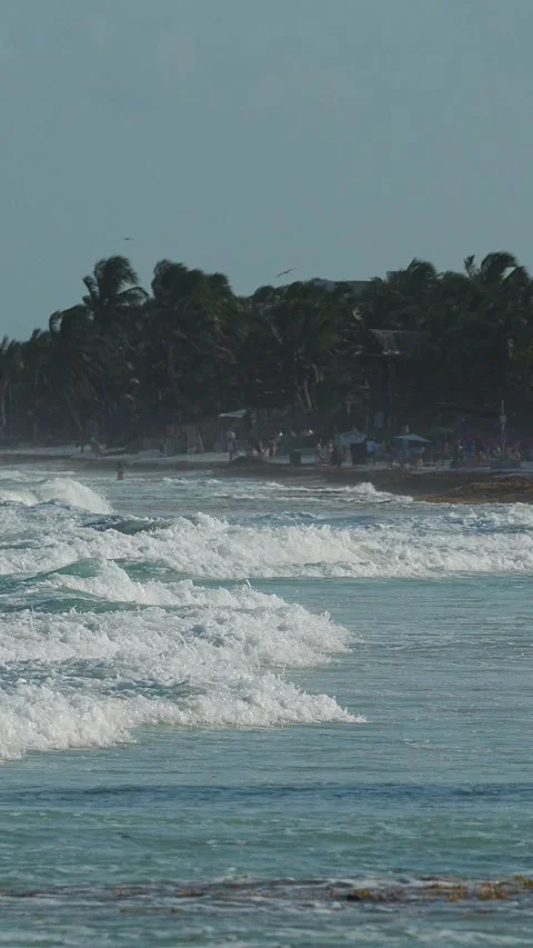 Ocean waves crash against the beach Stock Footage 345538837