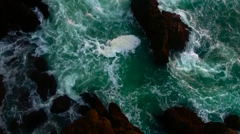 Ocean waves crash against a cliff in slow motion (aerial) Stock Footage 67712112