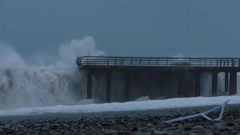 Ocean waves crash against a footbridge Stock-Footage 257083638