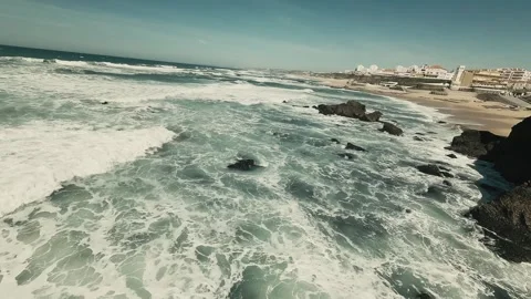 Ocean waves crash against jagged black rocks Stock Footage 341821939