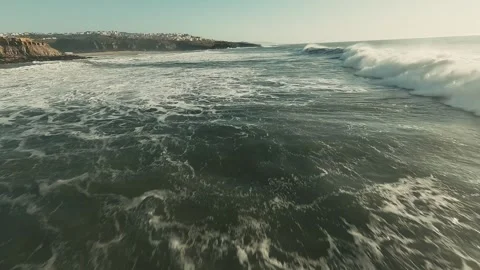 Ocean waves crash against rocky cliffs Stock Footage 339792175
