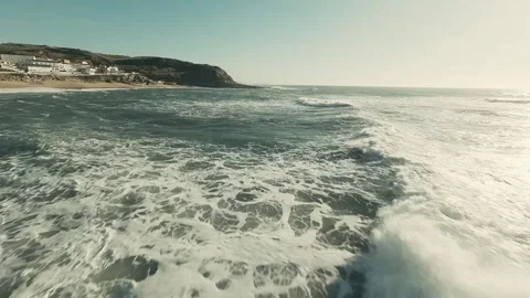 Ocean waves crash against a rocky shore Video stock 341826070