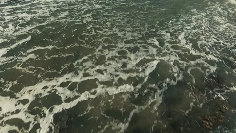 Ocean waves crash against rugged rocks Stock Footage 339790377