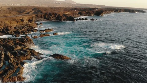 Ocean waves crash against sharp cliffs of shore, drone shot 스톡 동영상 104983569