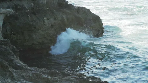 Ocean waves crash and splash water on coastal rock Stock Footage 86357307