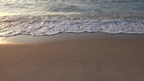 Ocean waves crash on the beach at dusk. 動画素材 250515306
