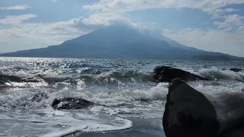 Ocean waves crash onto the beach 스톡 동영상 337696985
