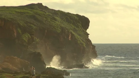 Ocean waves crash onto cliff behind golf course putting green B Video stock 125332863