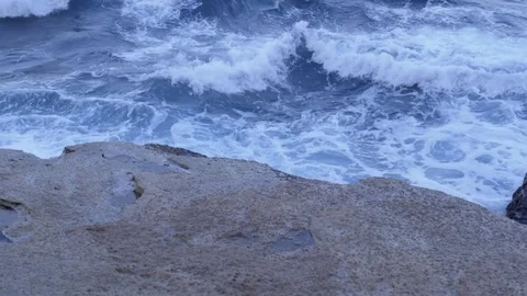 Ocean waves crash into cliff Stock Footage