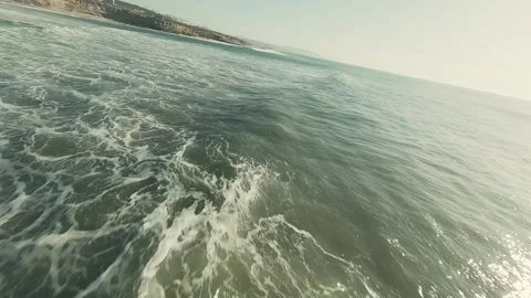 Ocean waves crash, creating white foam Stock Footage 339789873