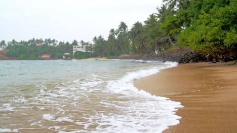 Ocean waves crash on deserted beach creating relaxing atmosphere 스톡 동영상 281366085