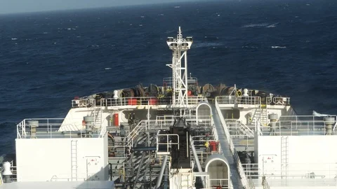 Ocean waves crash into modern vessel bow creating rainbow Stock Footage 114766943