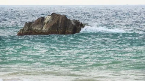 Ocean Waves Crash over a Big Rock at Hikkaduwa Beach Stockbeeldmateriaal 150767438