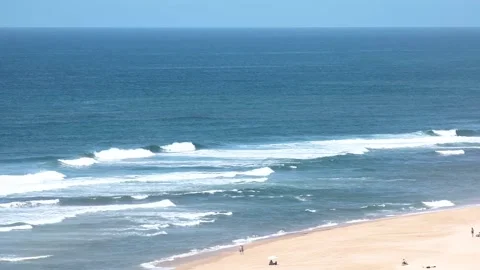 Ocean waves crash onto a paradise sandy beach on a sunny day Stock Footage 250981543