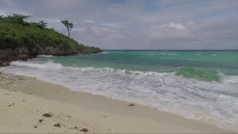Ocean Waves crash on sandy Bantigue beach, Malapascua island, Philippines Stock Footage 246596173
