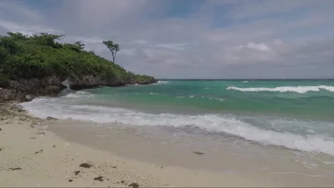 Ocean Waves crash on sandy Bantigue beach, Malapascua island, Philippines Stock Footage 246597524