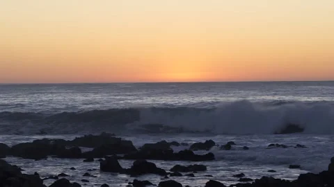 Ocean waves crash on shore as sun sets Stock Footage 141621290