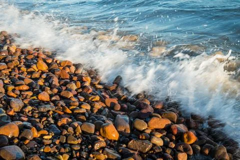 Ocean Waves Crash Upon Pebbled Shoreline at Bella Vista Beach Uruguay 写真素材