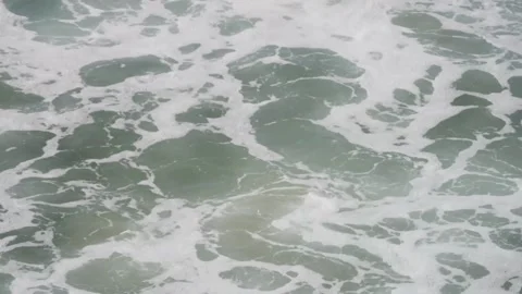 Ocean waves crash with white foam water surface Video stock 329544998