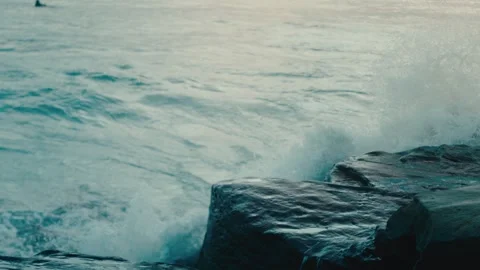 Ocean Waves Crashing Against Dark Coastal Rocks with Sea Spray in Moody Blue Stock Footage 342601767