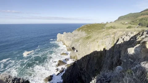 Ocean waves crashing against an empty stone rock cliff Stock Footage 242601738