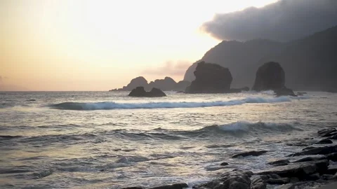 Ocean Waves Crashing Against Rocks at Sunset: Serene and Powerful Nature Fo.. Stock Footage 299799674