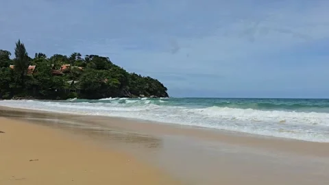 Ocean waves crashing against a sandy beach Video stock 340808142