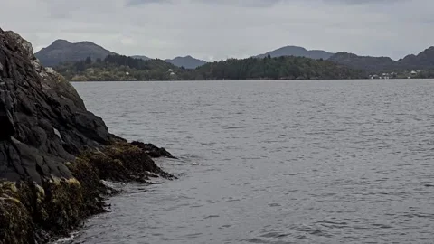 Ocean waves crashing against steep rocky cliff in Alver Norway Stock-Footage 345168136