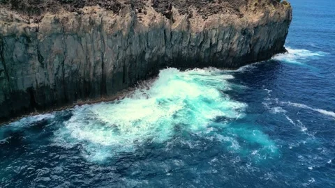 Ocean Waves Crashing Against Volcanic Basalt Cliffs in Azores Stock Footage 336307290