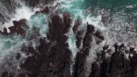 Ocean Waves Crashing Against Volcanic Rocks With Blue Green Water Stock Footage 343470538