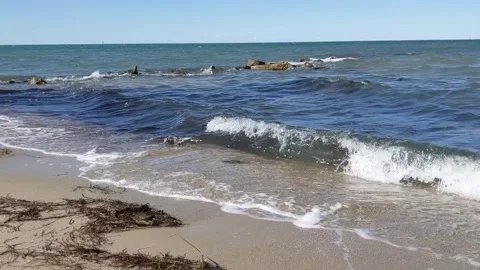 Ocean Waves Crashing with Algae and a Nearby Jetty Video stock 256875035