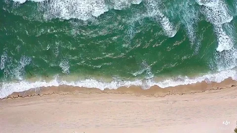Ocean waves crashing along the beach Stock Footage 162562825