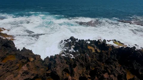 Ocean Waves Crashing on Ancient Million-Year-Old Red Coral Reef Shelf Stock Footage 337583156
